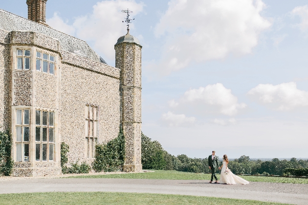 exterior of Slindon Manor with bride and groom walking up to the front