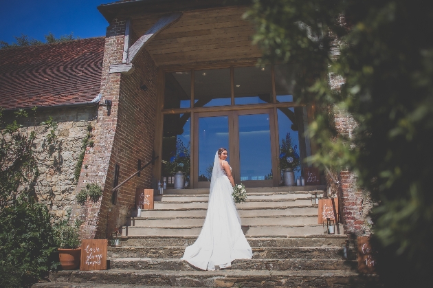 Bride on the steps of Bury Manor Barns