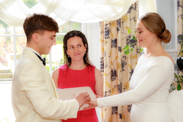 Jen Woodley conducting a wedding ceremony for a bride and groom.