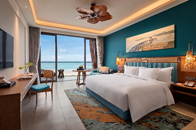 A colourful bedroom with views of the sea