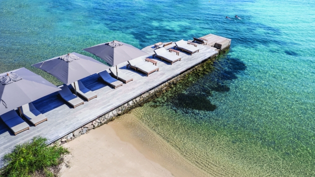 loungers on jetty in sea