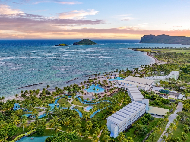 A sky view of a resort next to the sea